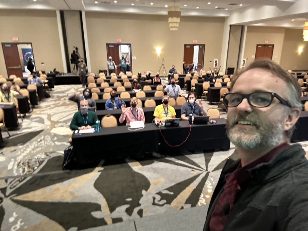 Selfie of Ryan Cheley with DCUS 2023 attendees in the background